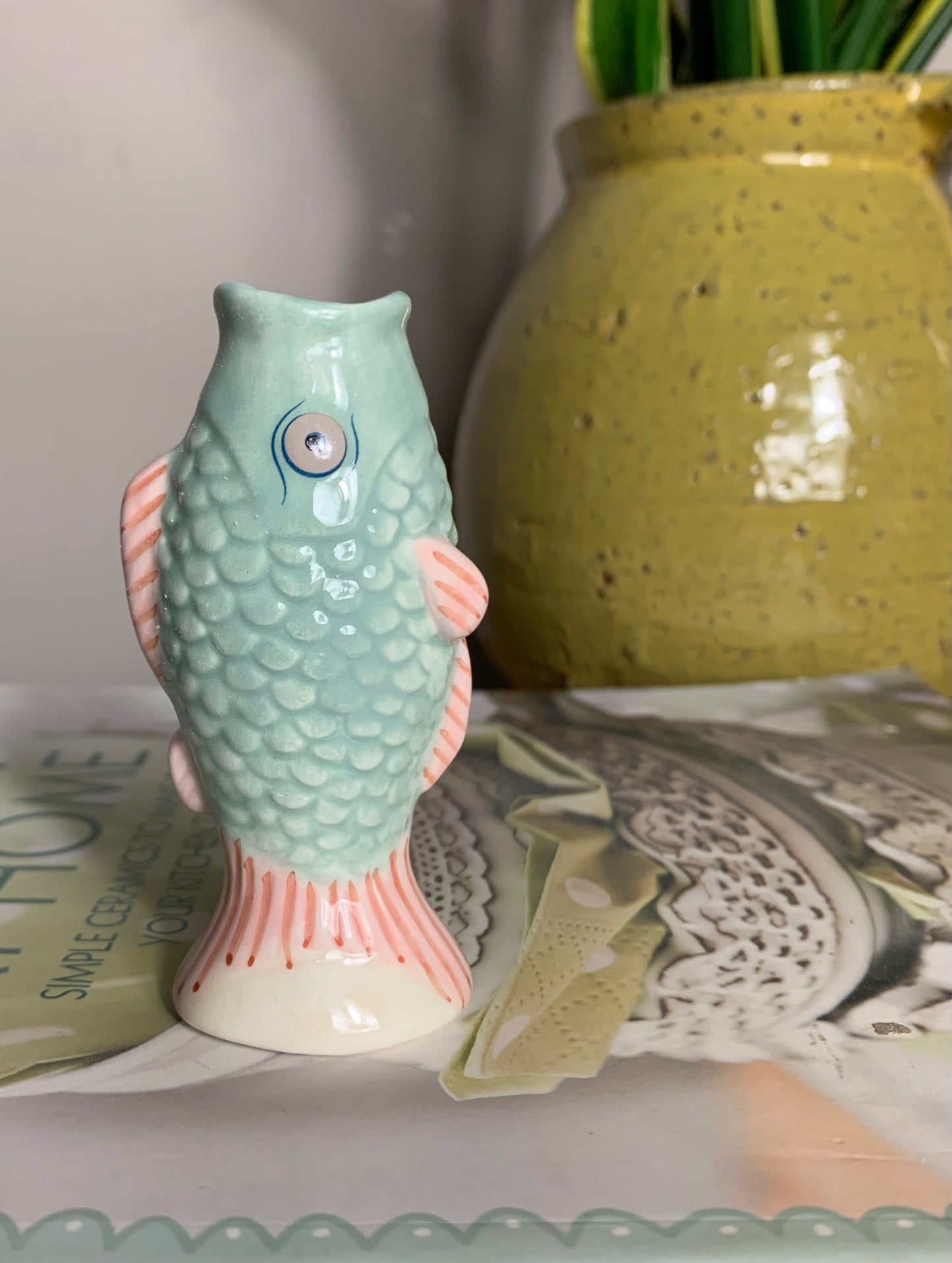 Small ceramic fish-shaped bud vase in mint green and coral/pink, glaze finish,