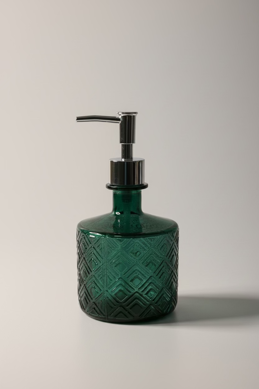 A dark green textured glass soap dispenser with a shiny chrome pump, set against a white  background.