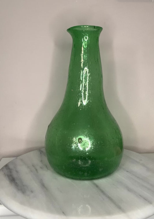 Emerald Green Bottle Decanter Carafe, hand-blown from recycled bubble glass with a characteristic pontil mark. Each piece features naturally occurring air bubbles throughout, a hallmark of the traditional glassblowing process. Beautiful as a standalone decorative object or paired with a set of recycled glasses.